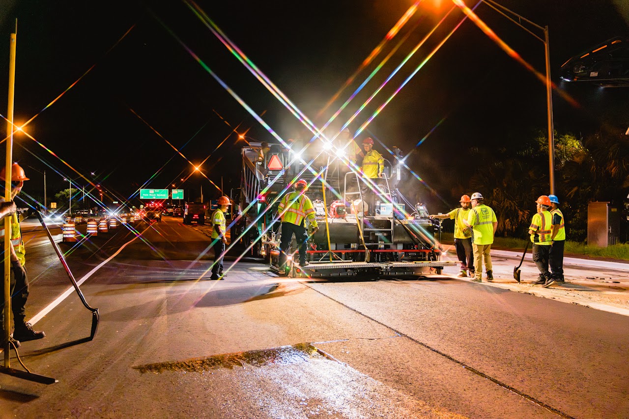 Fischman Asphalt night paving operation with CAT rollers on Florida highway